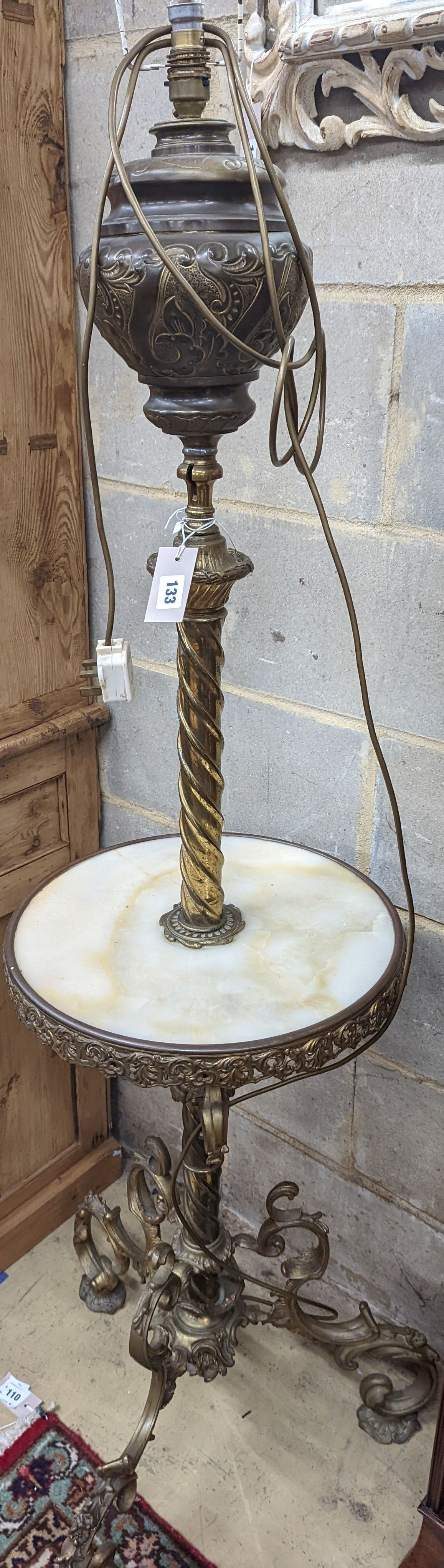 A late Victorian cast brass and onyx oil lamp standard, the column with an alabaster mid tier, raised on an open scrolled tripod base, converted to electricity, height 152cm